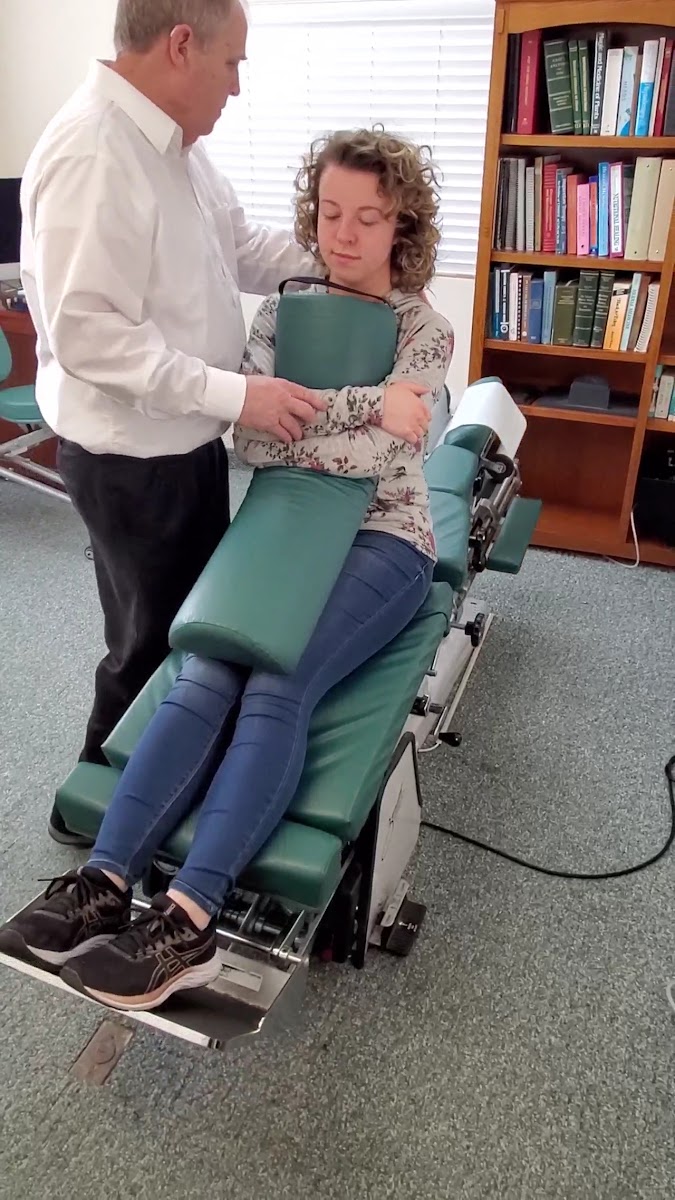Patient on chiropractic table with chiropractor