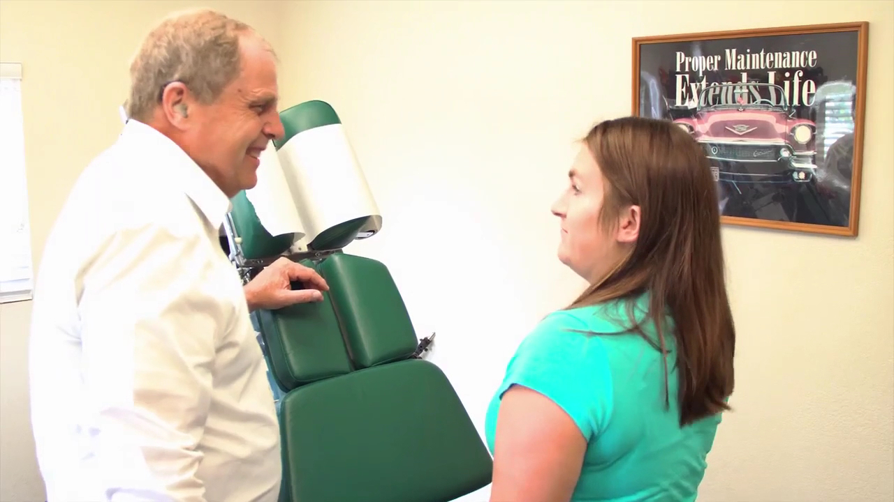 Chiropractor interacting with patient